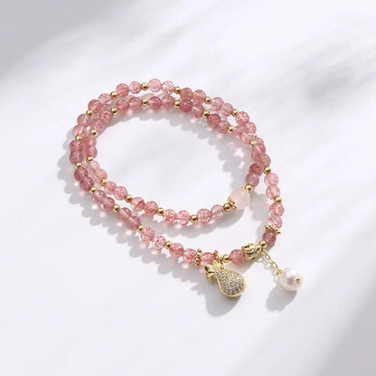 Geometric strawberry quartz crystal bracelet for women on a white background.