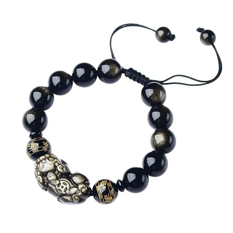 Handmade golden obsidian Pi Xiu bracelet with Chinese zodiac design on wrist.