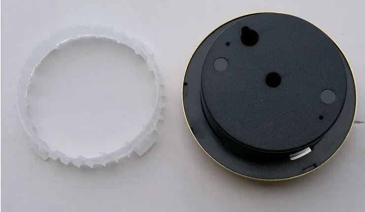 Analogue thermometer and hygrometer with aluminium outer ring and dial showing temperature and humidity scales