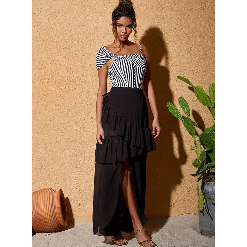 Women's striped one-piece swimsuit with ruffled design and black skirt overlay