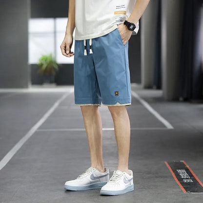 South Korea style loose straight-leg beach shorts in khaki on a plain background