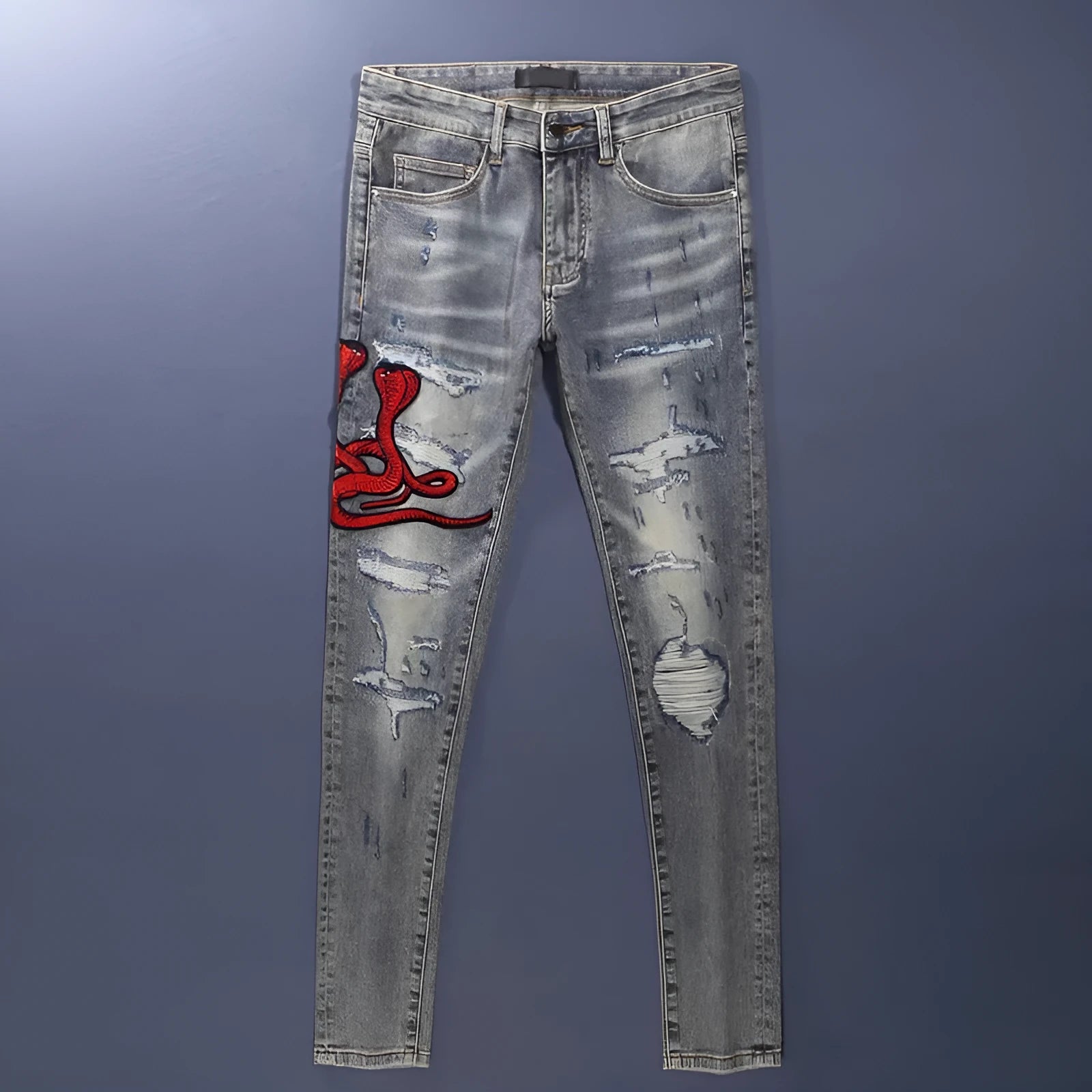 Men's slim fit cotton jeans with washed-out finish, hole patch detailing, and embroidery in old colour