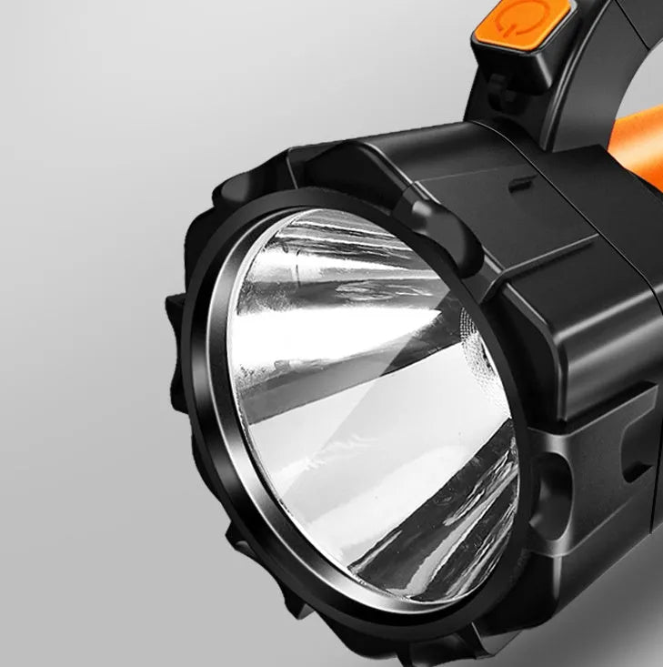 H771 portable LED searchlight in orange or green with shoulder strap and removable battery.