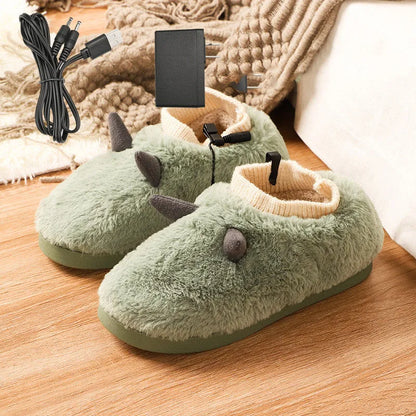 USB heating slippers in black plugged into a laptop, showing the cable and soft velvet upper.