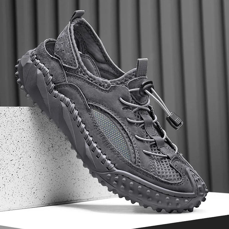 Men's black waterproof wading sandals with elastic band and perforated leather mesh upper on a rubber sole.