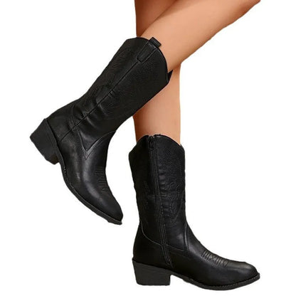 Women's black mid-calf boot with chunky rubber sole and pointed toe on a white background.