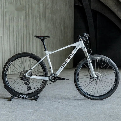 A black wall-mounted ABS plastic bracket holding a mountain bike vertically for storage.