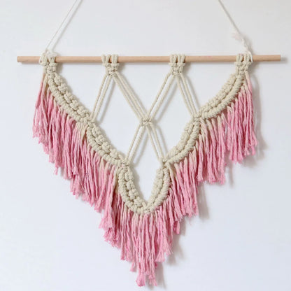 Handmade boho macrame wall hanging in pink cotton rope, 40cm high 50cm wide with wooden rod and natural seeds
