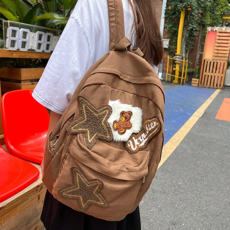 Brown canvas backpack with geometric patterns, ideal for female college students