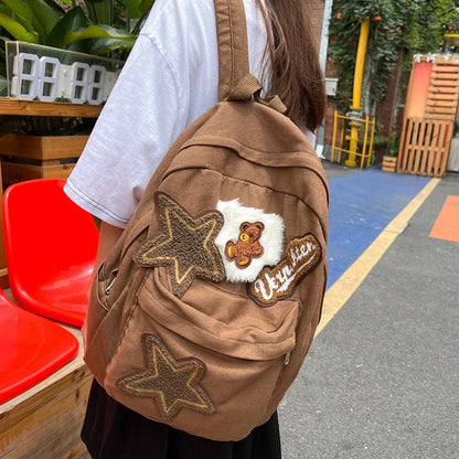 Brown canvas backpack with geometric patterns, ideal for female college students