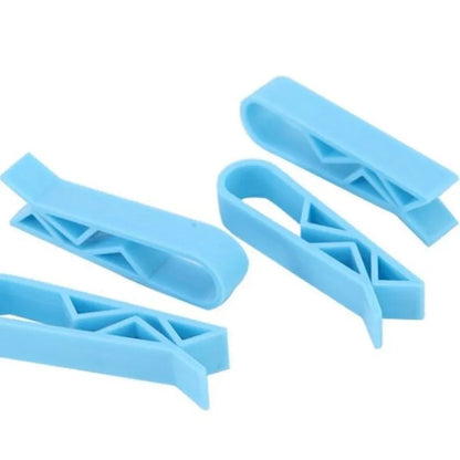 A white polypropylene plastic clip for holding a rubbish bag onto the rim of a bin.