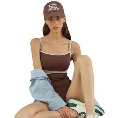 Brown women's one-piece swimsuit with triangle front and adjustable tie-back straps on a neutral background.