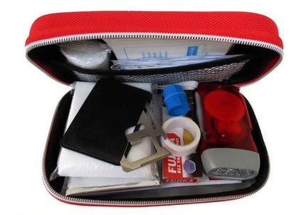 Red plastic survival first aid kit open to show 18-piece contents including bandages, scissors, and emergency blanket.