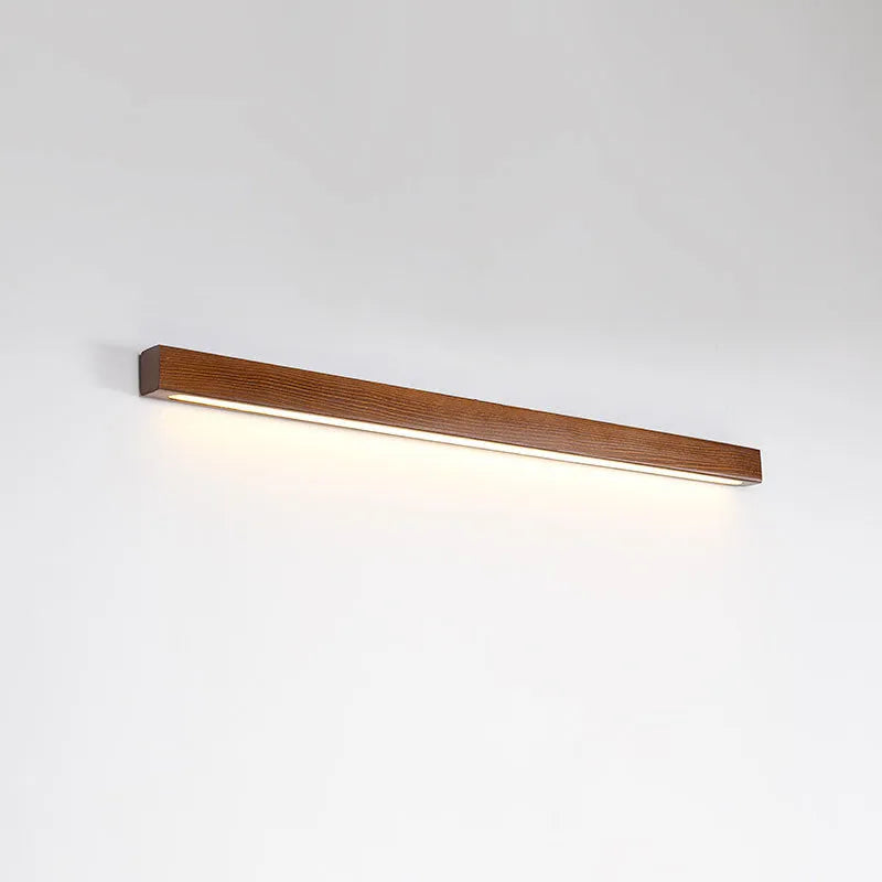 Walnut coloured wooden strip wall lamp with acrylic diffuser, mounted flush on a wall.
