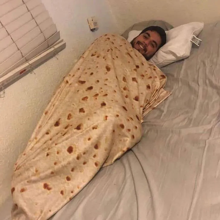 Round flannel burrito blanket with food-themed printing, showing coral fleece texture and wrap-style design