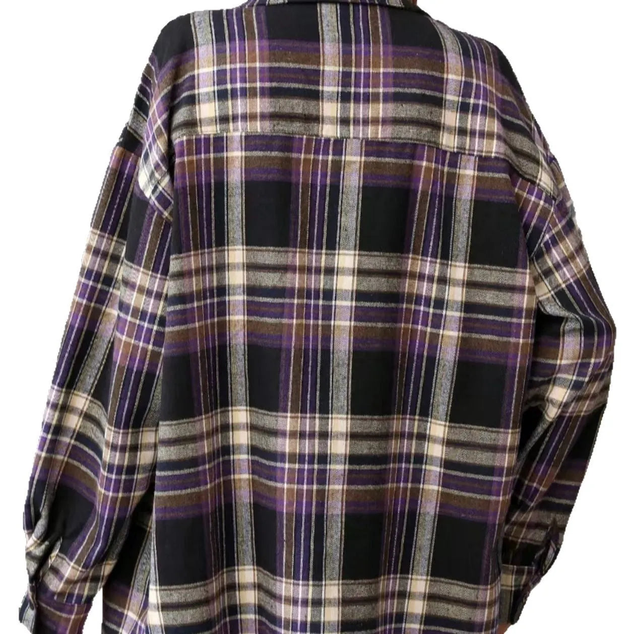 Woman wearing a loose-fit black and white plaid long sleeve shirt made from 100% cotton.