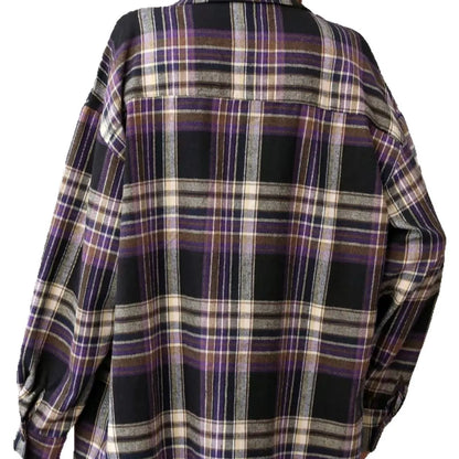 Woman wearing a loose-fit black and white plaid long sleeve shirt made from 100% cotton.