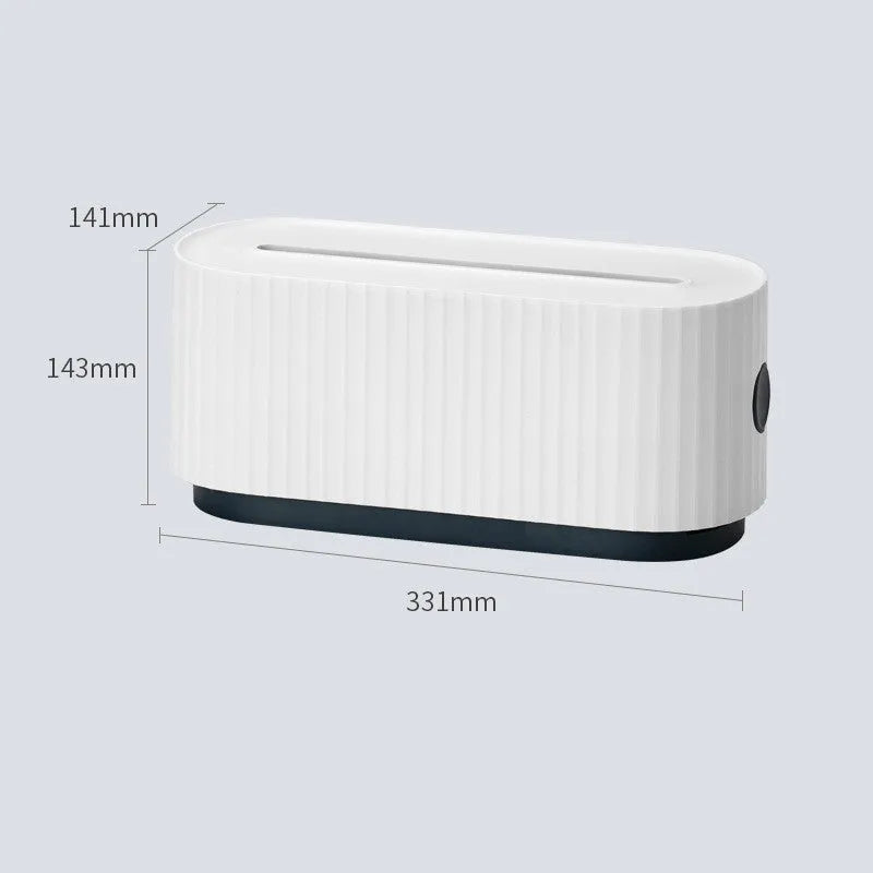 Blue desktop cable storage box with a white lid, showing cable ports on the base and a mobile phone sitting in its slot on top.