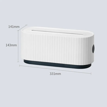 Blue desktop cable storage box with a white lid, showing cable ports on the base and a mobile phone sitting in its slot on top.
