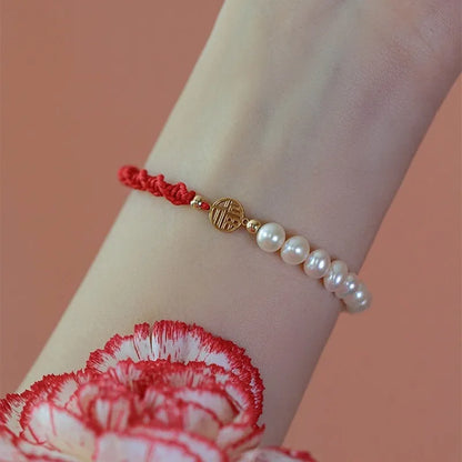 Women's pearl bracelet with braided red rope and geometric fu character charm