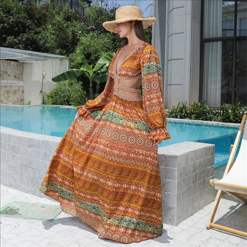 Elegant floral print dress with long sleeves and empire waistline in vibrant orange color