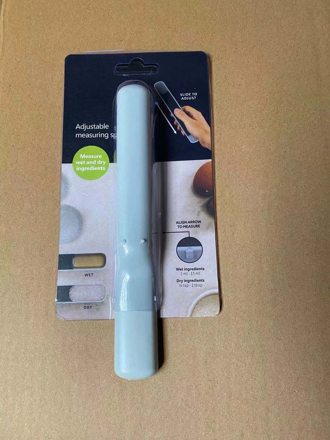 Adjustable 12-speed measuring spoon in grey, perfect for precise kitchen measurements