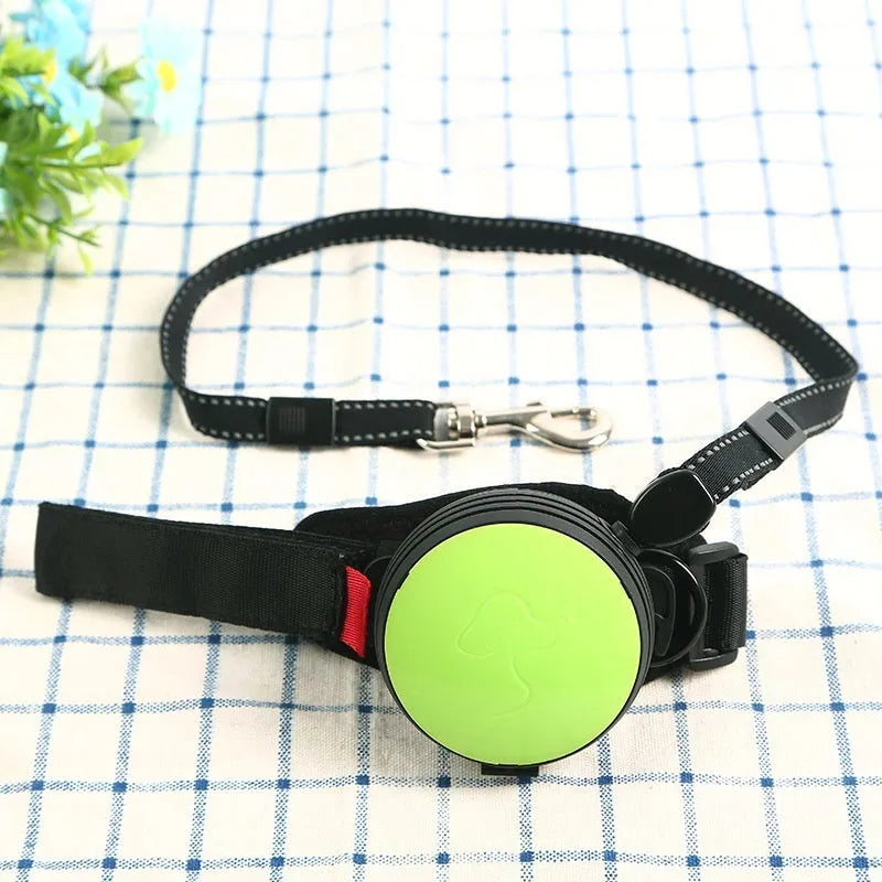 Retractable dog leash with handle and nylon cord in vibrant orange colour, extended to 3 metres.