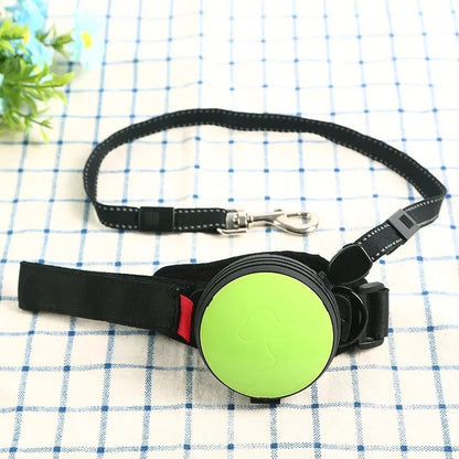 Retractable dog leash with handle and nylon cord in vibrant orange colour, extended to 3 metres.