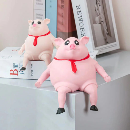 Adorable piggy-shaped stress relief toy made of eco-friendly rubber with a charming red scarf design