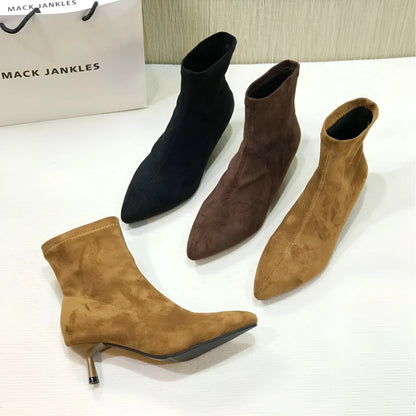 Women's black pointed toe ankle boots with a stiletto heel on a neutral background