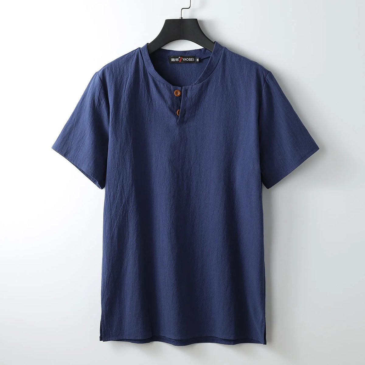 Women's loose fit apricot cotton V-neck short sleeve pullover top on a hanger.