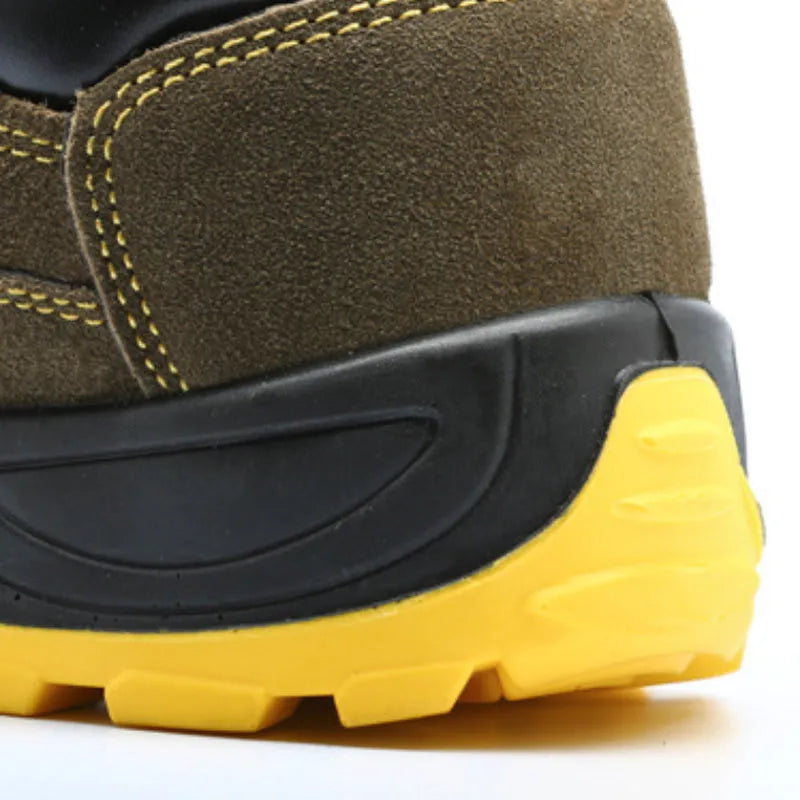 Bronze cow suede low-cut safety shoes with steel toe cap and patterned rubber sole on a workbench.