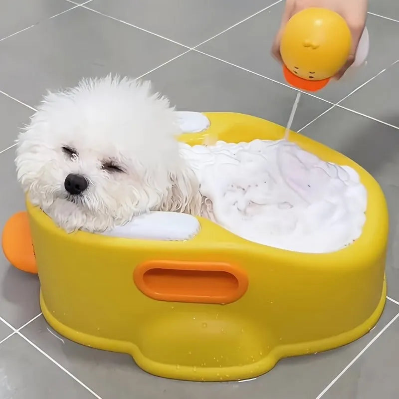 Blue PVC duck-shaped bathtub for washing a small dog, shown on a tiled floor.
