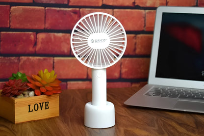 White ORICO FH1 portable USB rechargeable desk and handheld small fan with three speed buttons.
