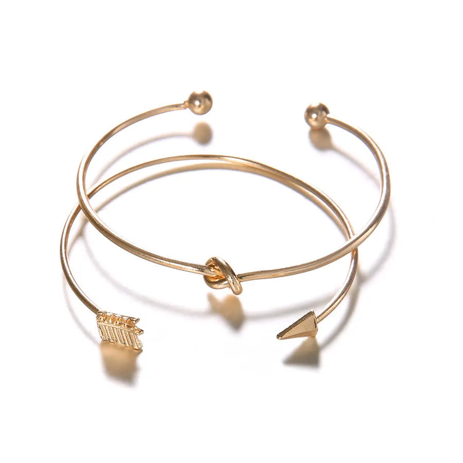 Gold-coloured vintage arrow knotted cuff bracelet for women.