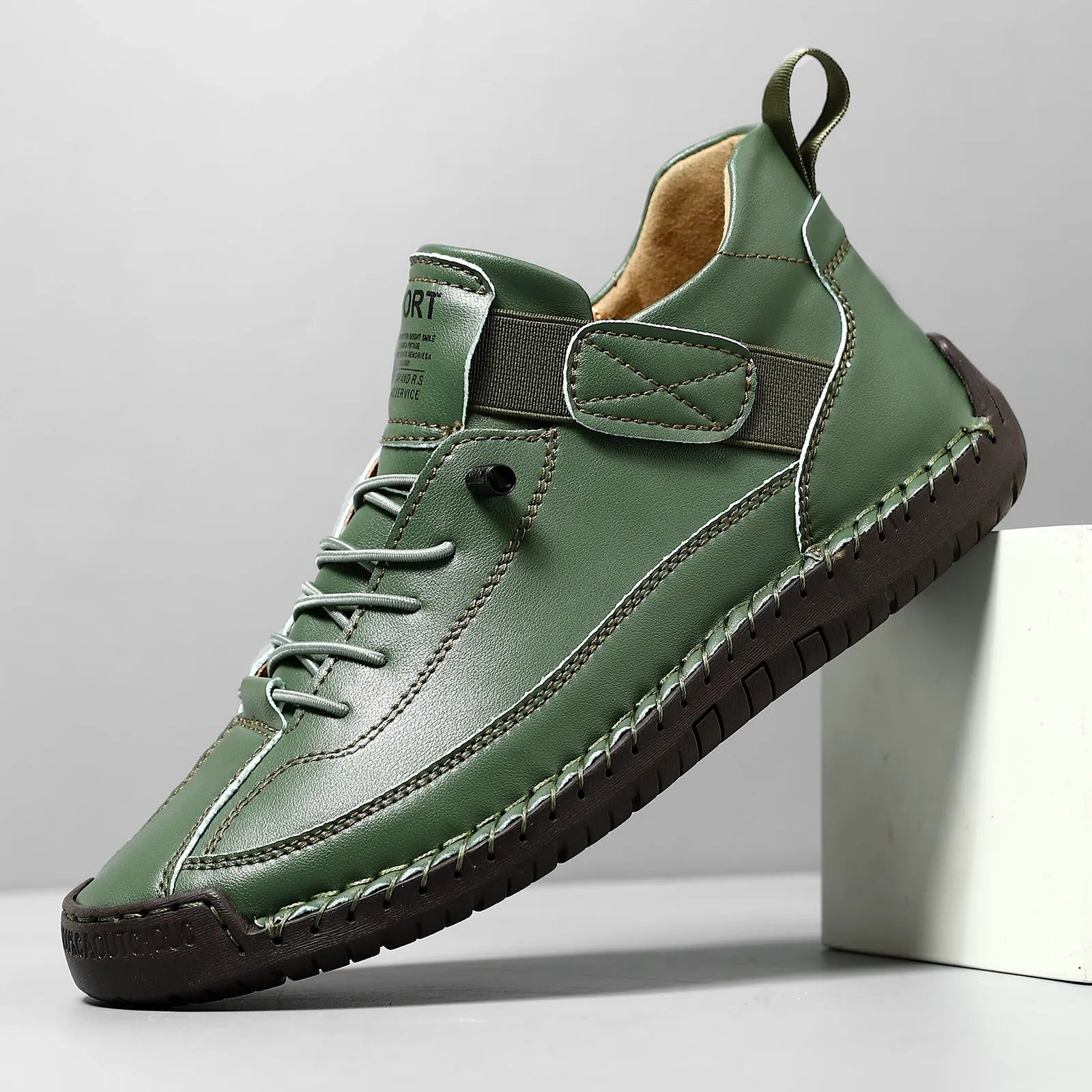 Men's black mid-top Martin boots with elastic band and sewn sole on a plain background.
