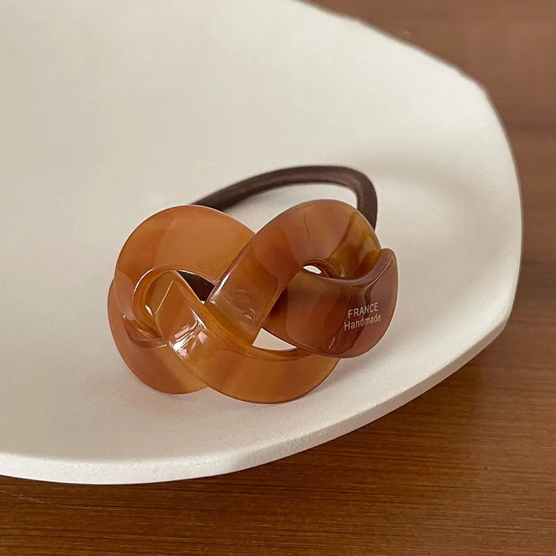 Seamless acetate hair rope ring in black, plaid, caramel, and dark coffee colours.