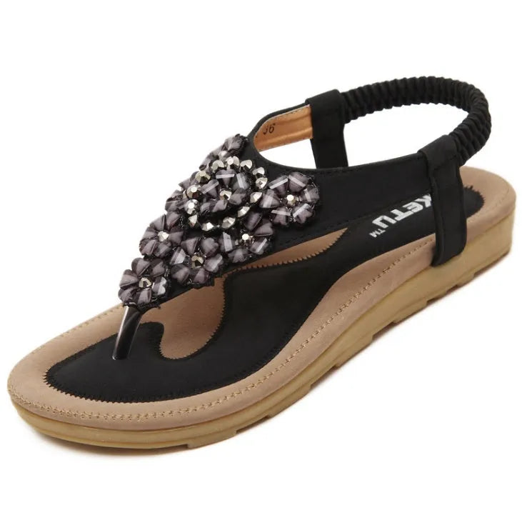 Women's flat sandals with floral rhinestone detail, open side, elastic ankle strap, apricot colour