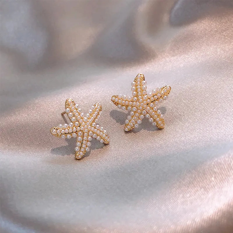 Korean style pineapple and starfish motif earrings with pearl accents in gold, silver, pearl flower, or starfish pearl finish.