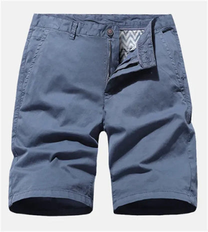 Man wearing blue denim loose-fit casual shorts with an elasticated waist, no belt.