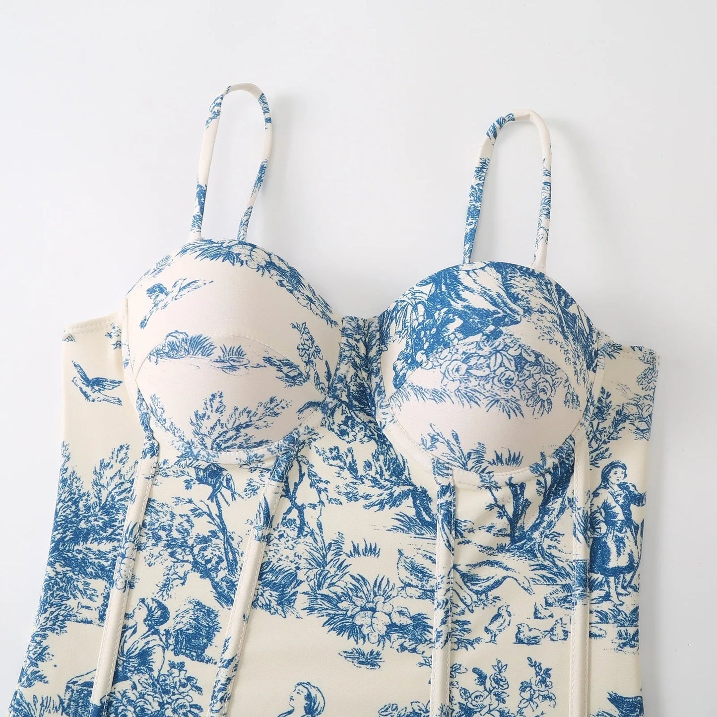 Blue women's one-piece swimsuit on a hanger with a separate gauze skirt.