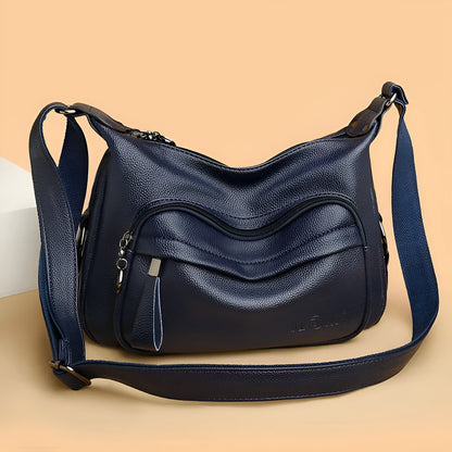 Large blue women's shoulder bag with crossbody strap and multiple internal compartments