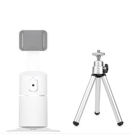 Black mini camera tripod with extended legs and a separate U-shaped universal phone clip on a table.