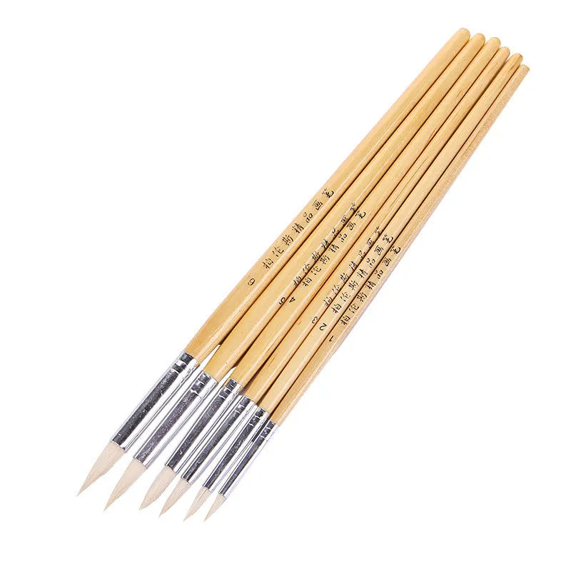 Six wooden-handled pen brushes with pointed wool bristles in conventional colours for artistic line work