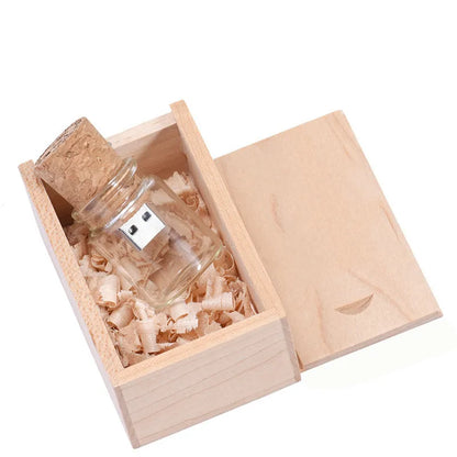 Chocolate brown wooden USB flash drive shaped like a drift bottle with custom engraved lettering on the side