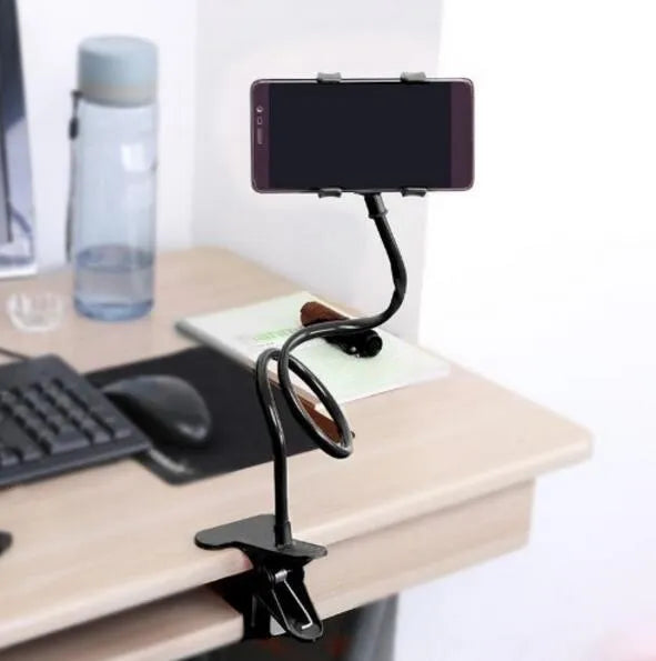 Black flexible long arm phone holder with V-clip gripping a smartphone, bent to position screen for bedside viewing.