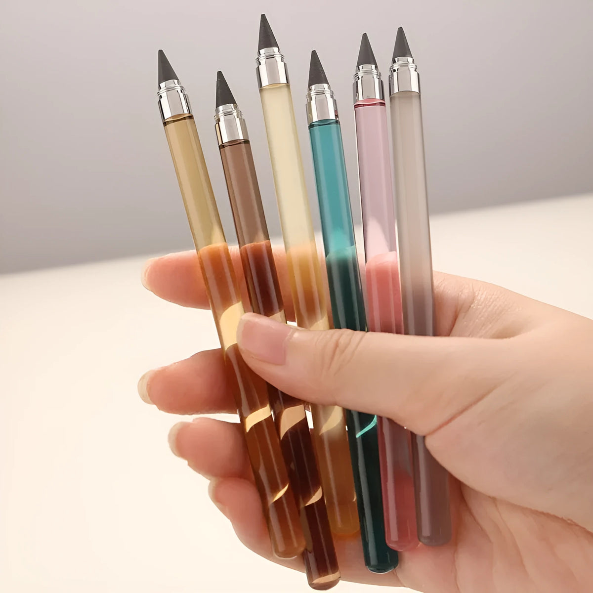 Transparent acrylic eternal pencil with alloy writing tip shown in multiple colour options