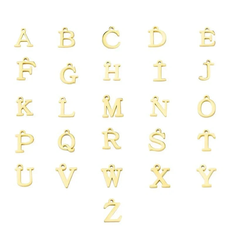 Elegant letter charm bracelets for women in gold and silver tones, featuring a delicate snake chain design and personalised letter charms.