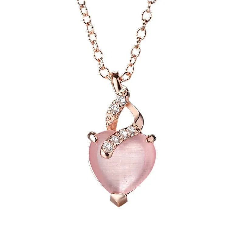 Women's rose gold heart-shaped pendant necklace with pink crystal centre on cross chain