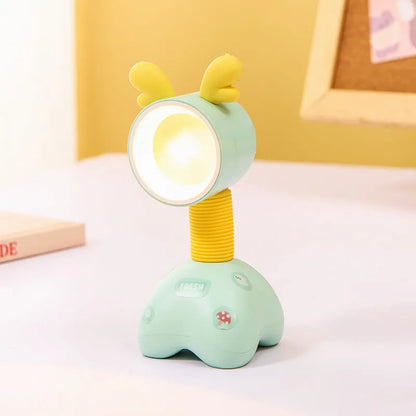 Colourful cartoon character magnetic DIY night light on a desk with adjustable head.